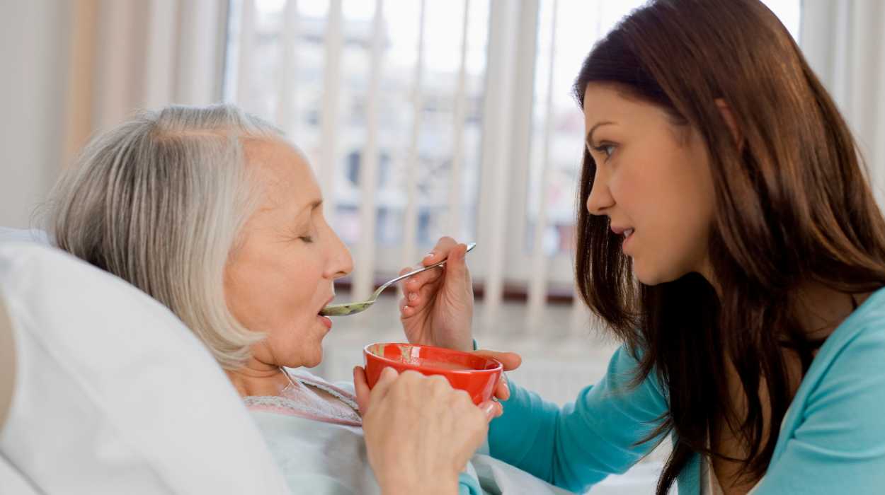 Young man taking care of his old mother