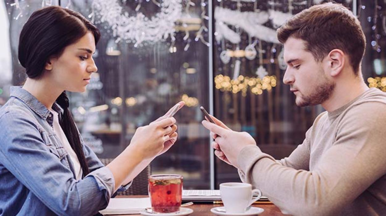 Couple ignoring each other in café